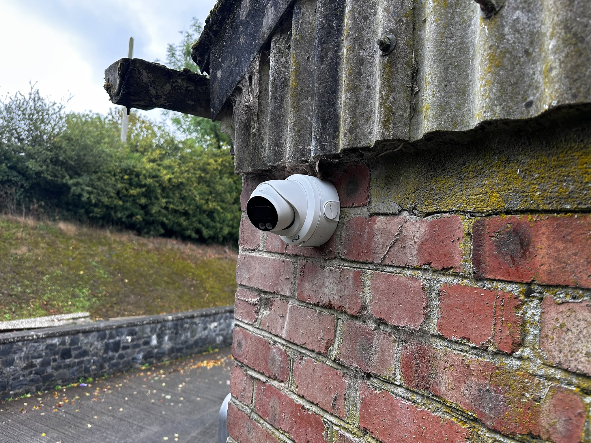 Dome security camera covering the entrance and pathway